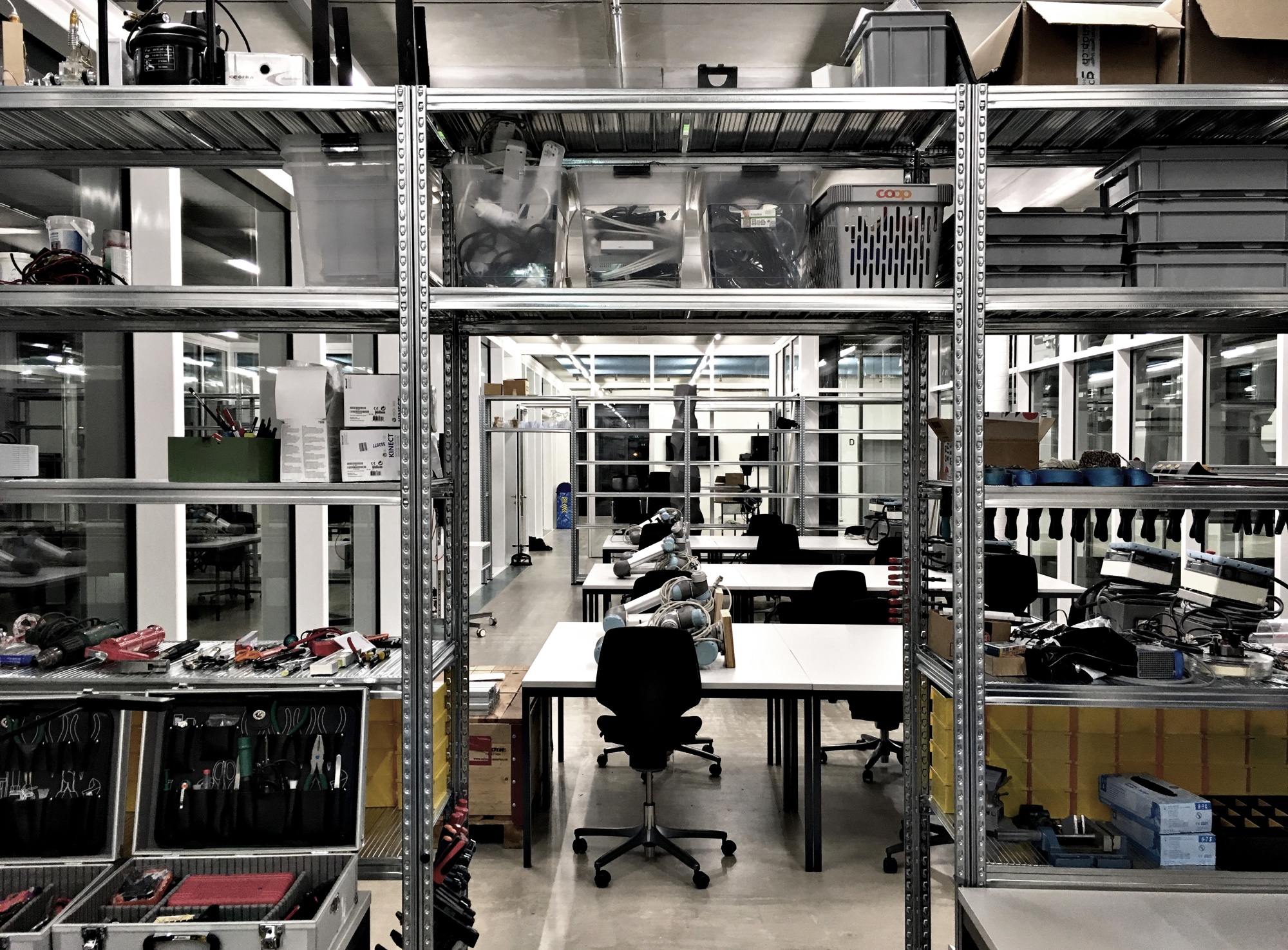 The MAS ETH DFAB cluster space containing the tools, workstations and robots used by the program